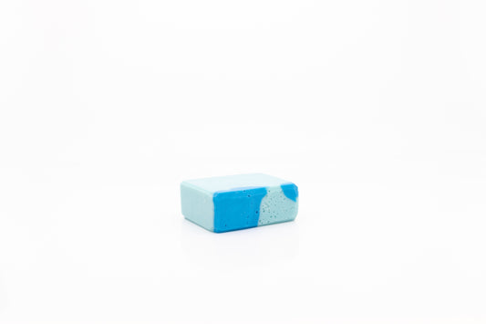 Vegan facial and body cleansing bar. It is light blue marbled with a brighter blue.