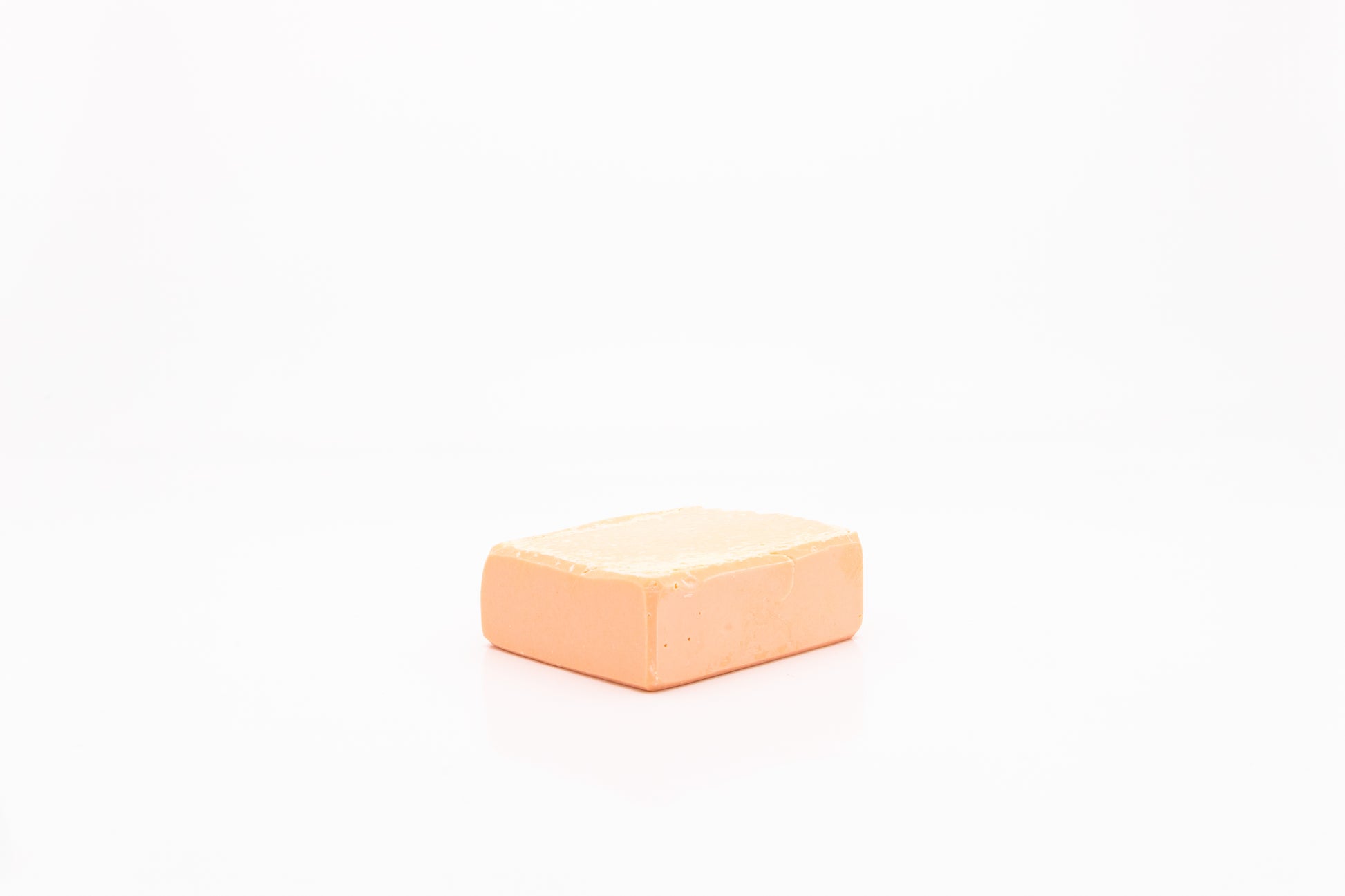 Peach colored, vegan facial cleansing bar. 