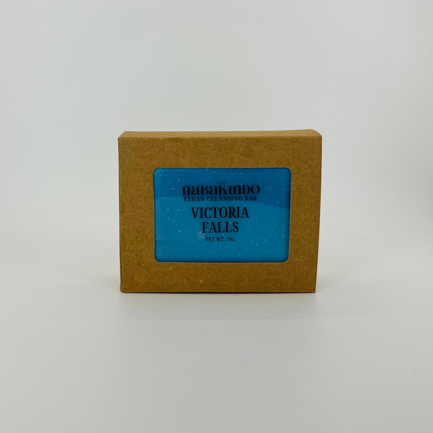 Photo of a blue, vegan, facial and body cleansing bar shown in sustainable packaging.